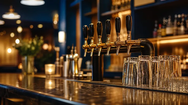 Tap handles and glassware on a polished bar, How to Start a Bar in Maine